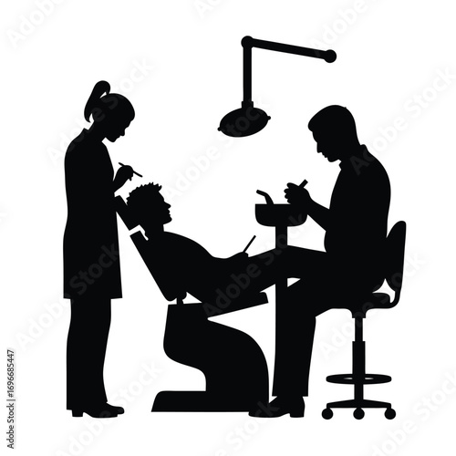 Dentist and assistant silhouette with patient and dental equipment