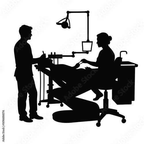 Dentist and assistant treating patient in dental chair Keywords: dentist, dental, treatment