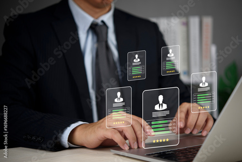Canvas Print Hiring Recruiter types on laptop to screen resumes and compare skills dashboards in a modern workspace, improving fairness and speed