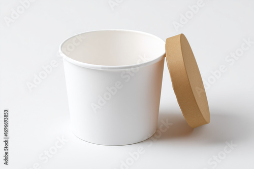 Ice cream cup paper food containers with one tilted forward. Eco-friendly disposable packaging used for takeout, soup, or meal service, isolated on a white background.
