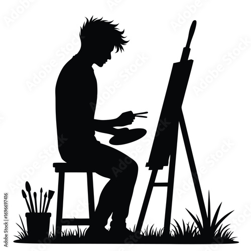 Silhouette of a man painting a portrait on an easel Keywords: silhouette, man, painting, artist
