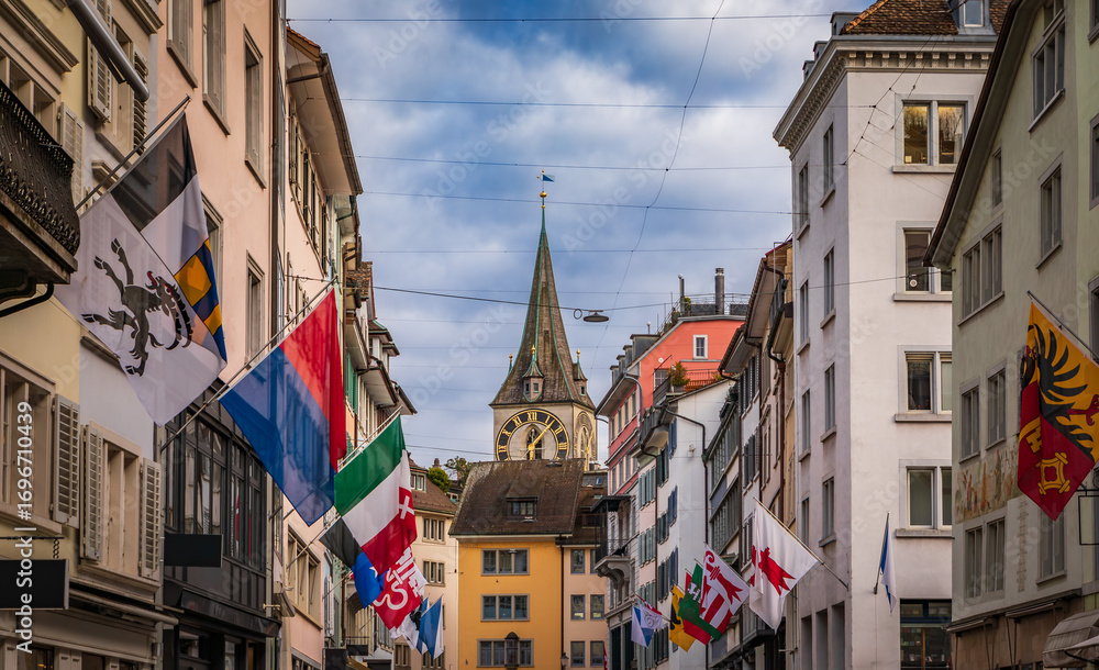 Fototapeta premium St Peter Church tower from Rennweg decorated with flags, Zurich, Switzerland