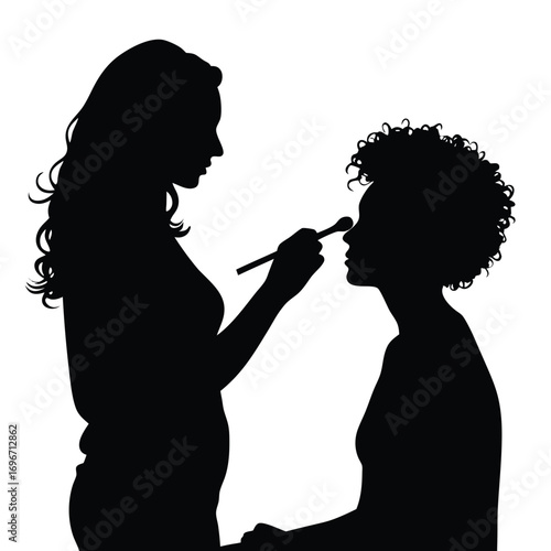 Silhouette of makeup artist with long hair applying makeup