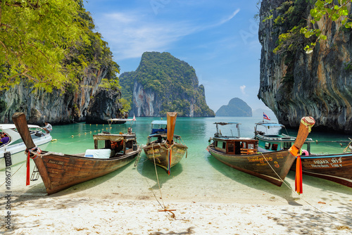 Krabi, Thailand - March 2021: Scenic bay of Koh Lao La Ding island with thai traditional fishing boats, destination island for tourist in Krabi, Southern of Thailand.