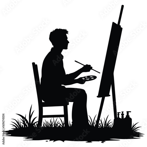 Silhouette of a man painting on an easel with paint bottles