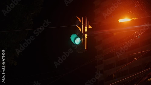 traffic light switches from green to red at night at an intersection