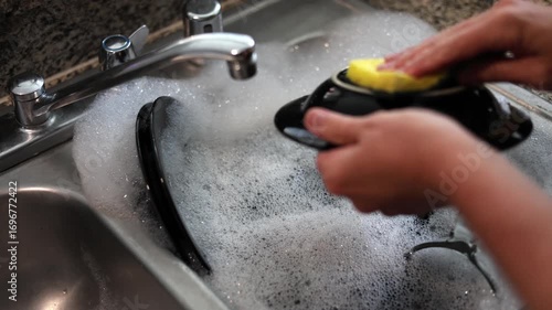 Washing Dishes In A Household Sink