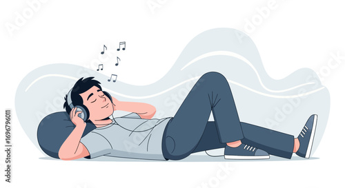 Relaxing Young Man Reclining And Listening To Music With Headphones