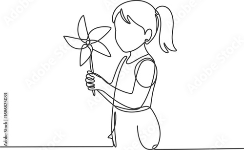 Joyful child with a colorful pinwheel on a sunny day