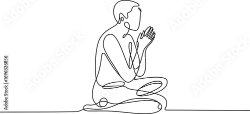 Person in meditative pose, hands clasped in prayer or contemplation