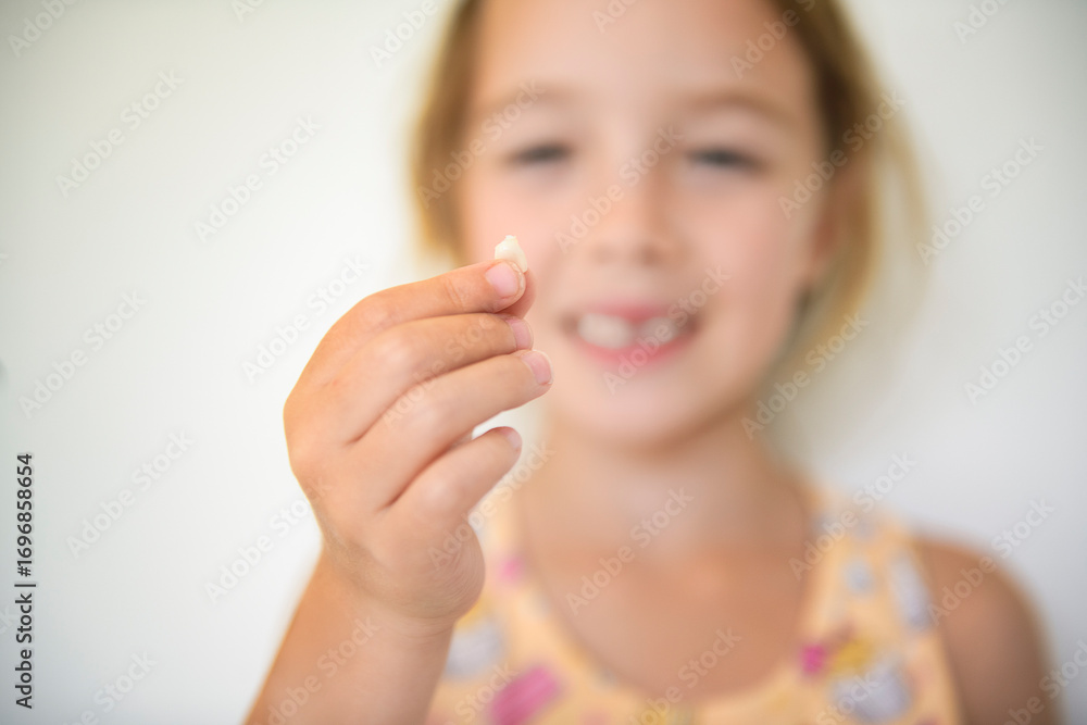 Smiling little girl missing tooth on white background Smiling little girl missing tooth on white background