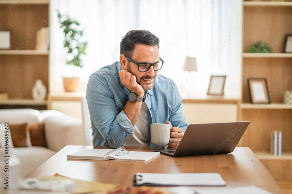 Obraz premium One adult caucasian man work on laptop computer at home