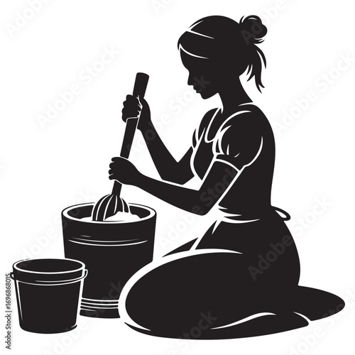 Silhouette of a woman in traditional clothing kneeling and stirring a large bucket with a wooden paddle preparing food