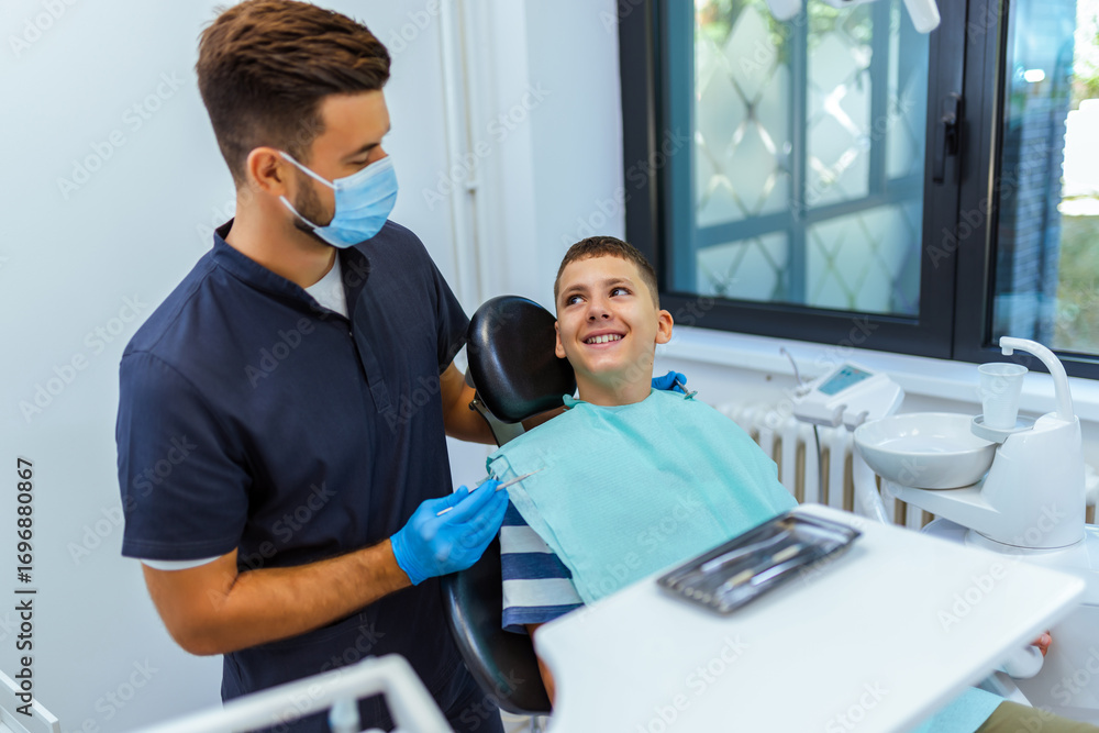 Fototapeta premium Dentist Examining Boy’s Teeth in Modern Dental Clinic