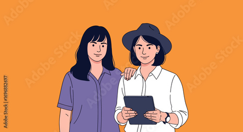 Two stylish women one with a tablet and hat in a friendly pose.