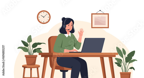 Woman with headset waving hand while working on laptop at wooden desk.