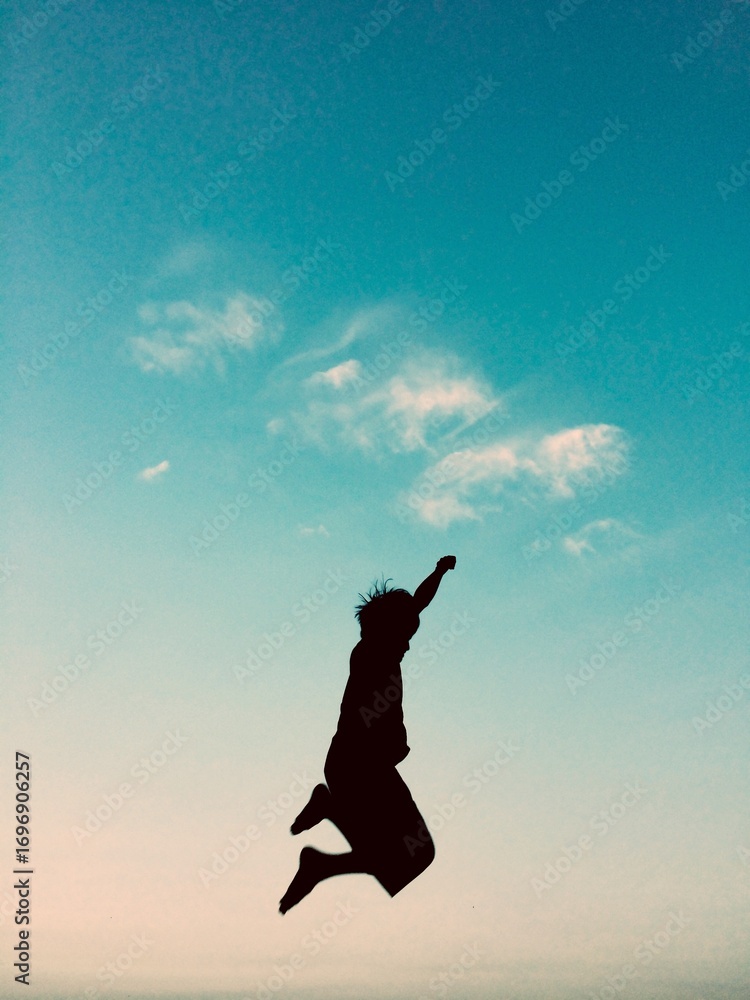 Fototapeta premium a small child jumping at dusk