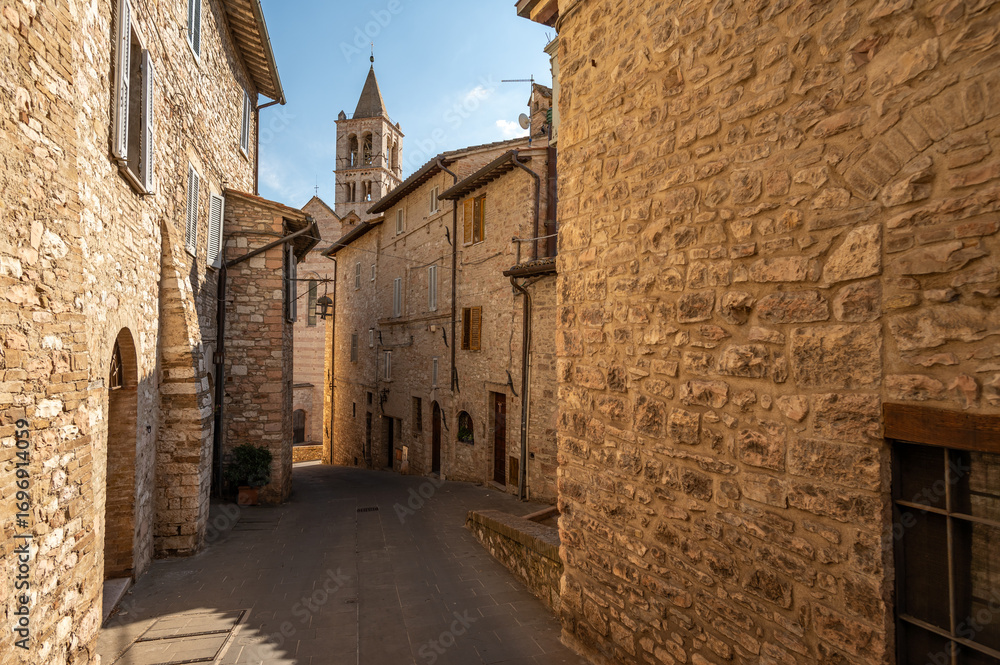 Naklejka premium Beautiful Tuscan historical street and place in the city of Assisi, Tuscany, Italy, Europe. Medieval atmosphere