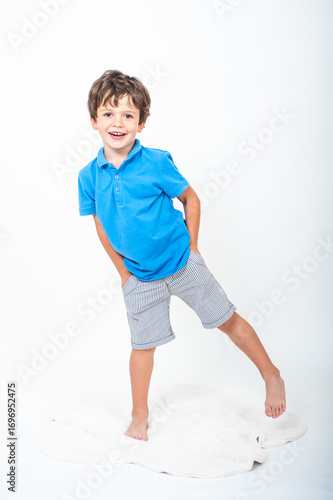 Young boy plays joyfully on a white background