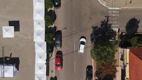 Drone aerial footage of city streets and residential buildings with traffic at sunset