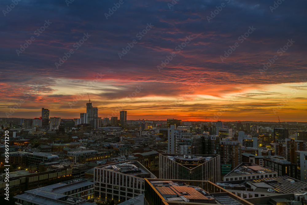 Fototapeta premium Aerial View of Leeds City Skyline at Dawn During a Vibrant Sunrise