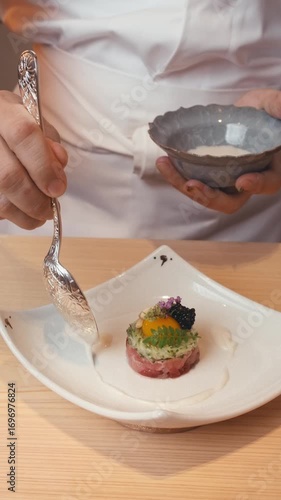 close up asian food preparation of traditional sushi rolls. presentation of dishes of Asian haute cuisine in Michelin-starred restaurant. chef hands create cuts decorates dish slow motion. Chef coat