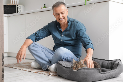 Mature man petting cute cat...
