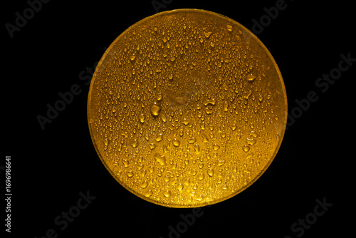 water drops on a gold metal disk  