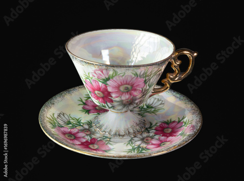 Beautiful tea cup with flowers and gold handle