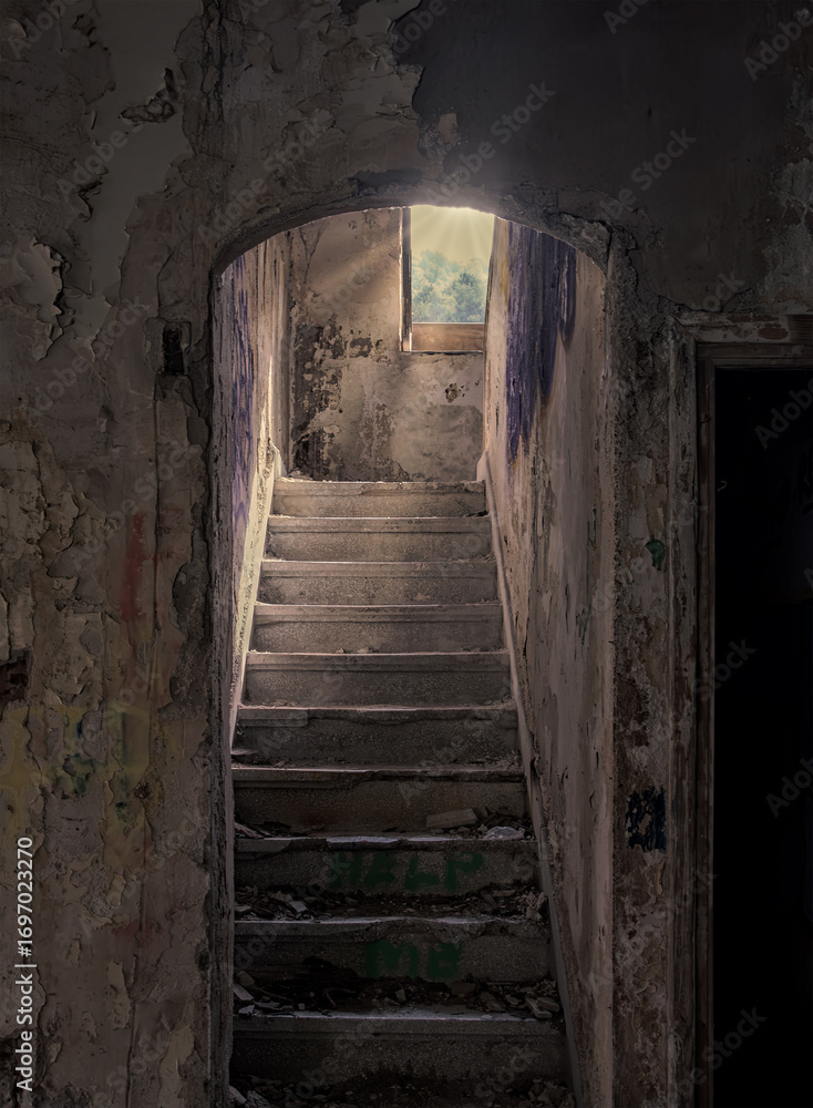 Fototapeta premium Stairs to the light in an abandoned factory