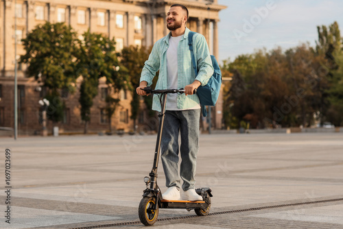 Handsome young man riding e...