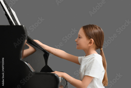 Young girl playing grand pi...