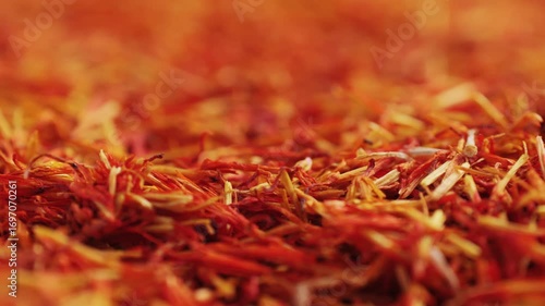 Dried crimson saffron on grey desk close-up macro. Orange red spice for food. Crocus sativus flower saffron