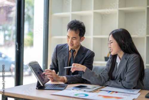 Wallpaper Mural Business colleagues discussing data analysis on tablet in office meeting Torontodigital.ca