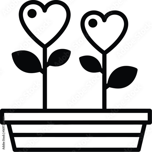 Two heart-shaped flowers blooming in a planter, symbolizing love and growth