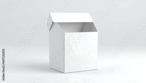 A white, open cardboard box, angled slightly, on a plain white background.  The box has a square shape and a hinged lid, currently raised.  The box is empty