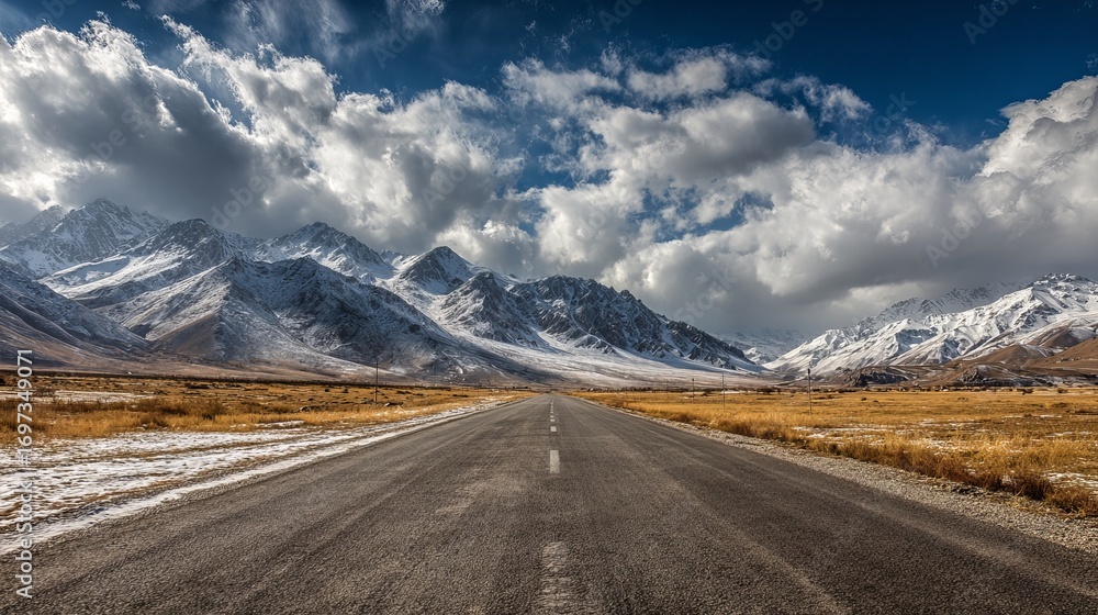 Naklejka premium Embark on an unforgettable road trip adventure through stunning mountain scenery with snow-capped peaks and endless blue skies