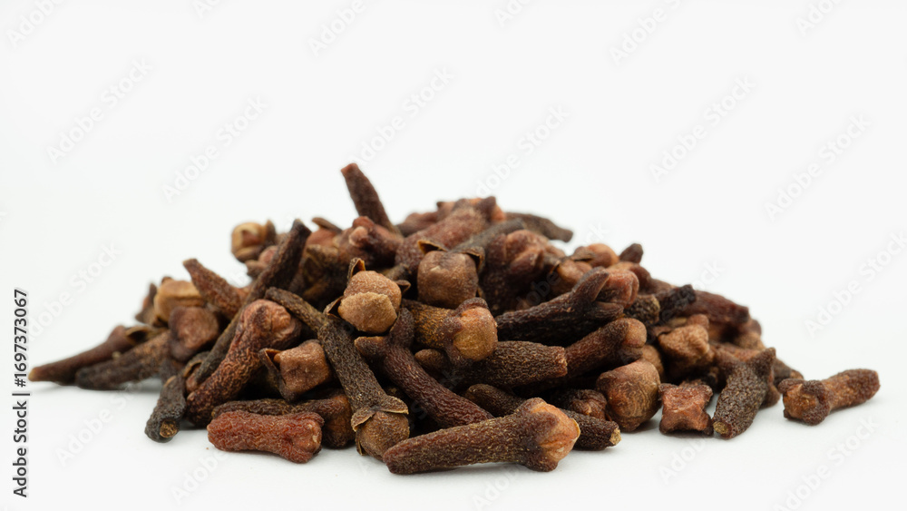 Fototapeta premium Cengkeh or cloves are aromatic dried flower buds. Dried cloves isolated on white background with clipping path. Flat lay or top view.