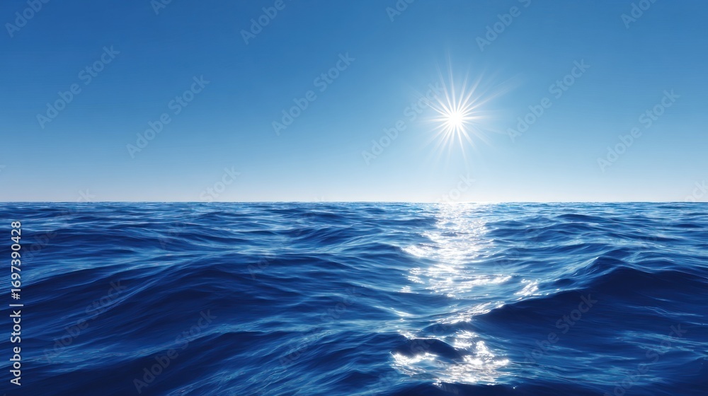Obraz premium A bright sun glints on blue ocean water under a clear sky, creating a serene, wide-open seascape
