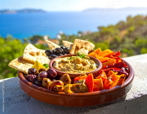 Hummus platter with pita bread olives and grilled peppers mediterranean appetizer plate