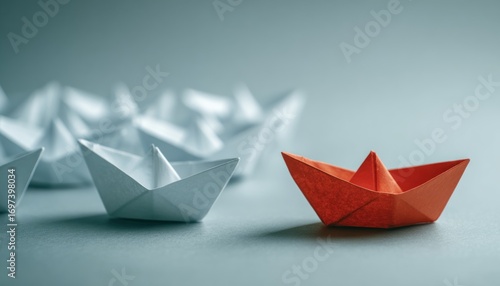 Wallpaper Mural A line of white paper boats led by a single prominent orange origami boat against a muted, teal-tinged background Torontodigital.ca