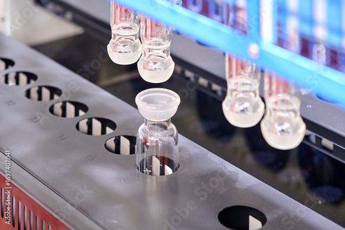 Pharmaceutical industry, production line preparing empty glass vials for filling