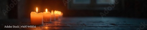 Glowing vigil candlelight illuminates a dark space, creating a serene and somber atmosphere Perfect for remembrance, peace, or spiritual themes The soft light casts gentle shadows , feeling, soft