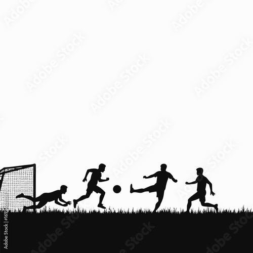 Silhouette of soccer players during a game on grass