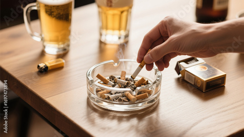 The melancholic man was holding a cigarette, and there was also beer on the table.
