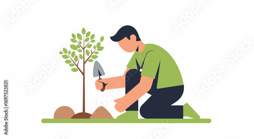Man in a green shirt and cap kneels on the grass, carefully planting a young tree sapling with a trowel.