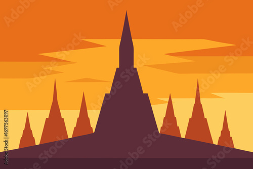 Silhouette of buddhist stupas against a vibrant orange and yellow sunset sky