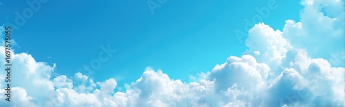 A panoramic vista of puffy white clouds clustered below a clear, light-blue sky, creating a serene and airy atmosphere