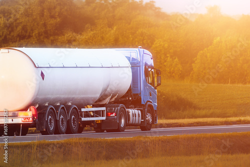 Gasoline tanker truck driving on asphalt highway