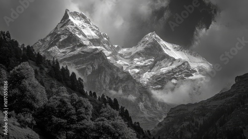 Majestic snow-capped peaks pierce a dramatic sky